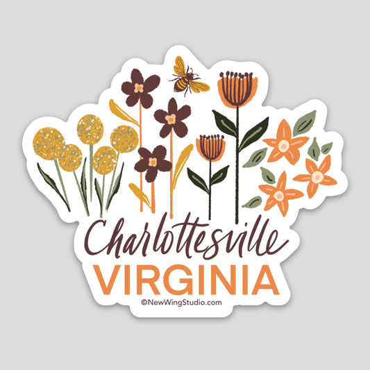 This beautiful sticker features illustrations of wildflowers in yellow, brown, orange, and green with “Virginia” in bold orange lettering with a bumble bee buzzing through the flowers.  The word “Charlottesville” is in an elegant hand-penned script between the flowers and “Virginia.”  The sticker’s dimensions are 3.29 inches by 2.27 inches and are made of durable, weatherproof vinyl.  The sticker is created by the artist Jennifer Knight from New Wing Studio.